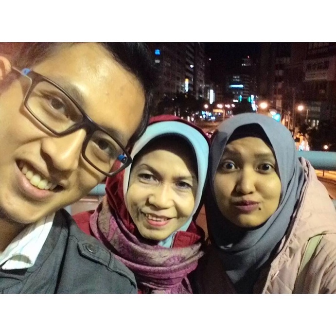 We took a picture nearby our inn with the busy street of Taipei as a background